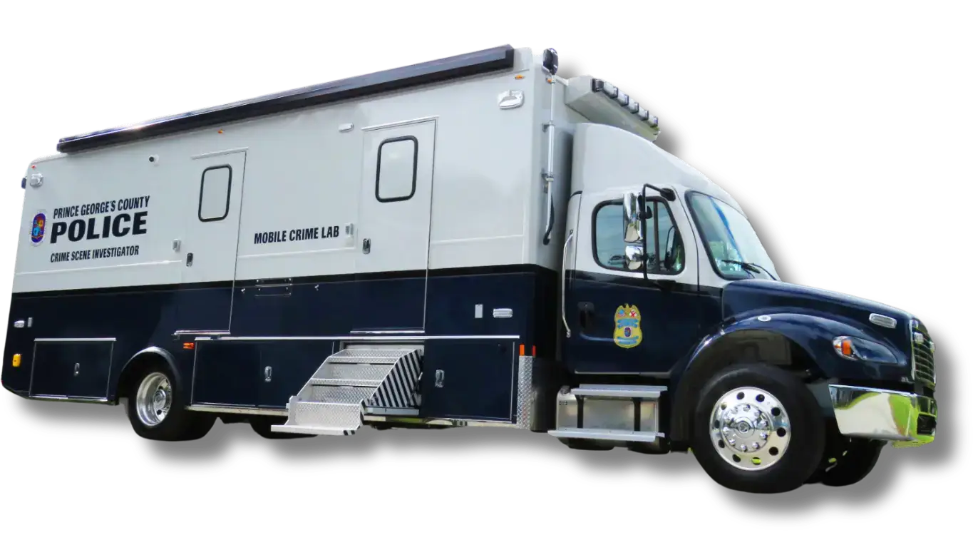 A large white and dark blue Prince Georges County Police mobile crime lab vehicle is parked, featuring official decals and stainless steel steps on its side.
