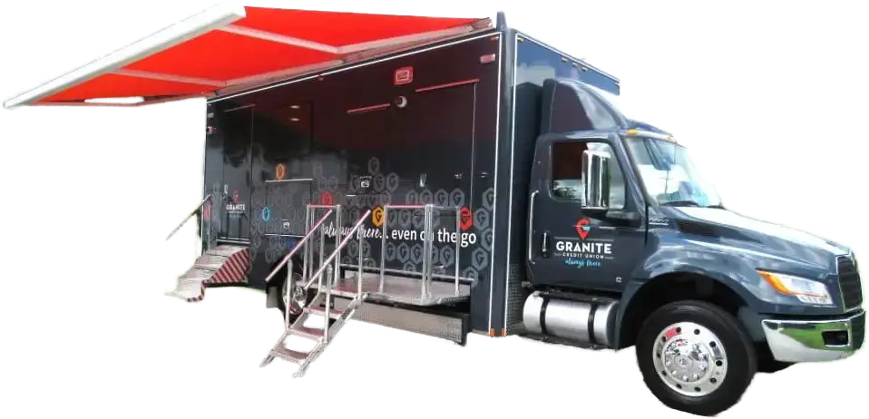 A large black mobile truck with a red awning, side entrance stairs, and handrails. The truck displays the Granite Credit Union logo and is designed for on-site financial services or community activities.