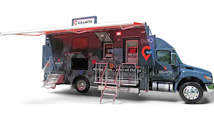 A mobile banking truck with Granite Credit Union branding, an open awning, steps leading to the entrance, an ATM, and service windows visible on the side of the vehicle offering convenient financial services.