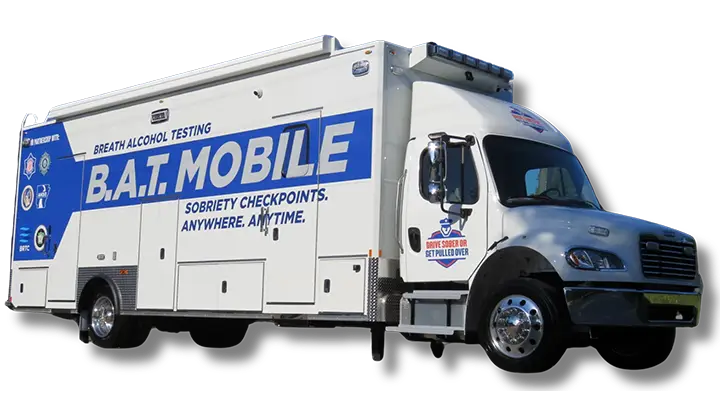 A large white and blue Volusia County Sheriffs Office Public Safety Vehicle labeled B.A.T. MOBILE for breath alcohol testing, featuring Sobriety Checkpoints. Anywhere. Anytime. and various logos on the side.