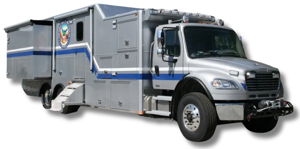 A large silver and blue Nevada National Guard mobile command vehicle with multiple compartments, official seal, side steps, and a slide-out section, parked on a flat surface.