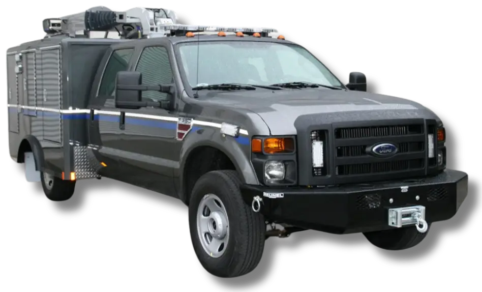 A large, gray armored RIV truck with a Ford badge, roof-mounted equipment, side compartments, and a front winch. Used by the Nevada National Guard, the vehicle features off-road tires and orange lights on the cab roof.