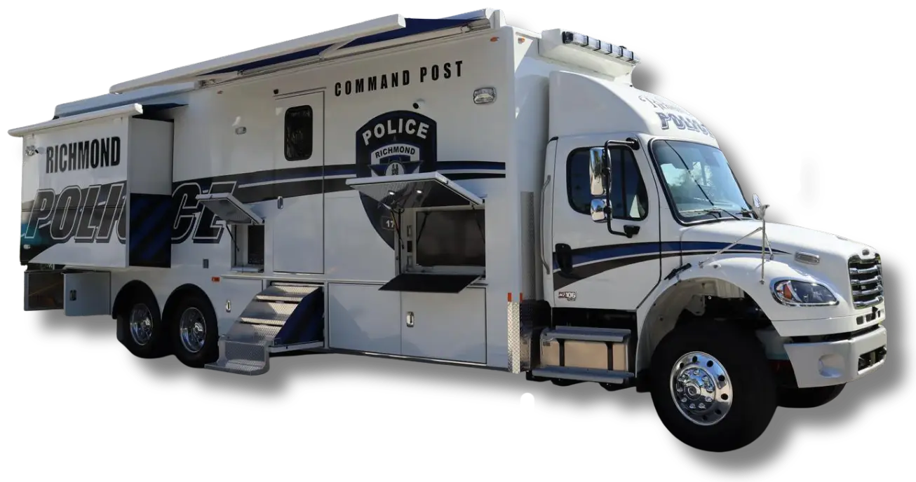 A large white and blue Richmond KY Police Department Command Post vehicle with three axles, multiple windows, steps to the entrance, and police markings on the side, parked on a flat surface.
